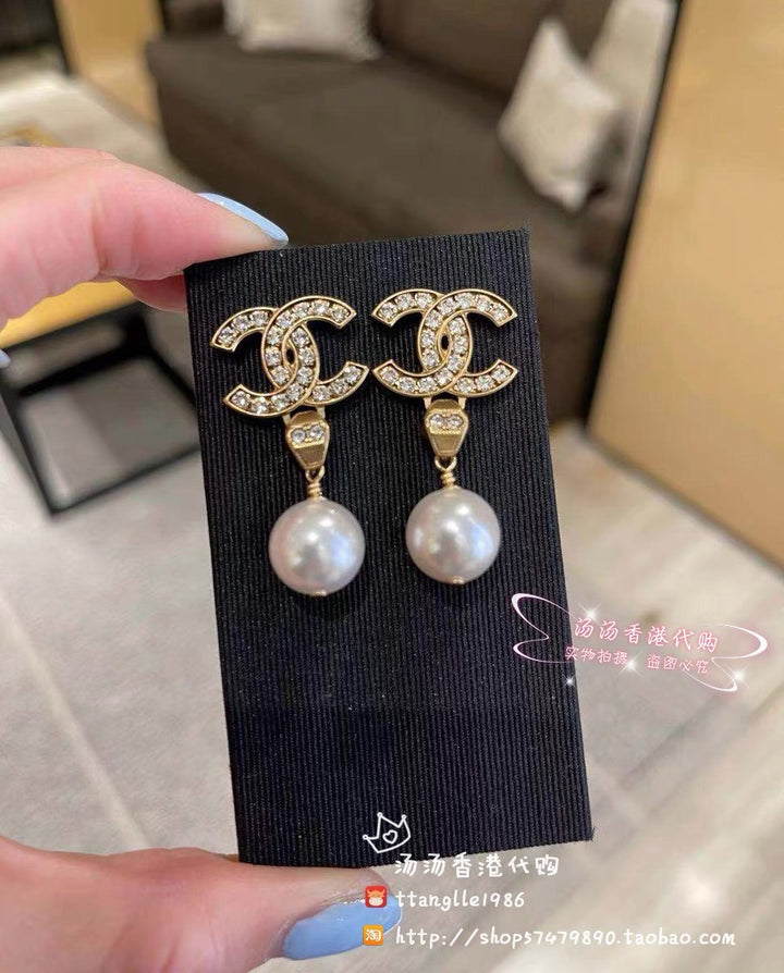 New double C gold coloured dangling pearl earrings