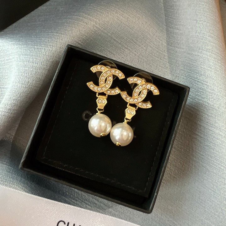 New double C gold coloured dangling pearl earrings