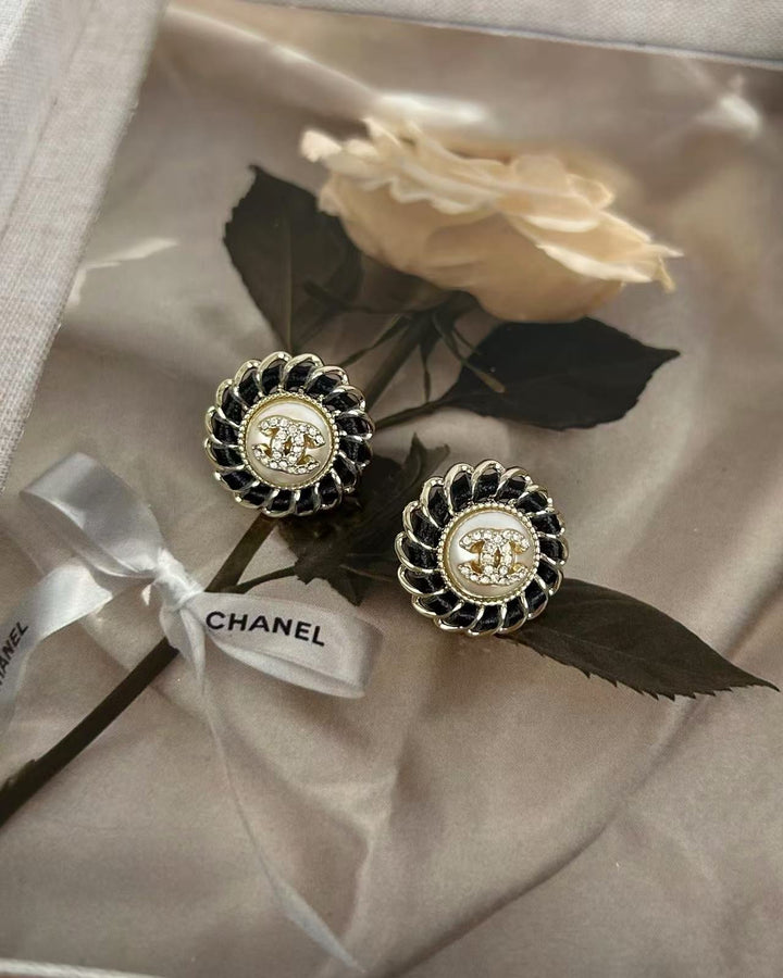 Black pierced leather rhinestone round earrings