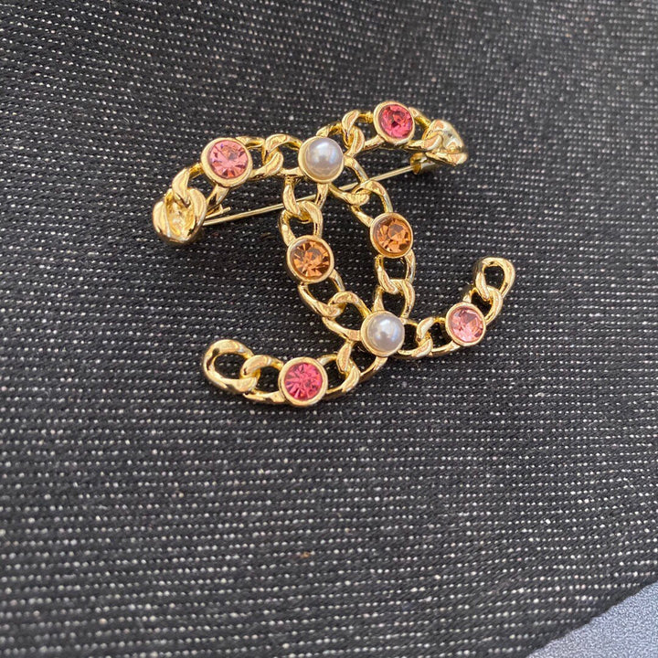 Gold-colored rhinestone brooch