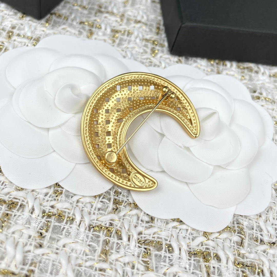 Gold crescent moon brooch